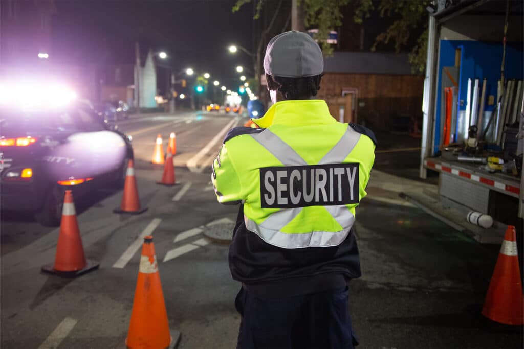 a static security guard observing a construction site at night