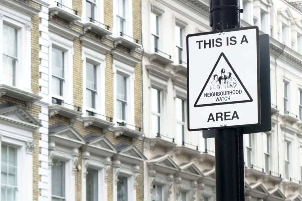 a neighbourhood watch sign in a wealthy london area